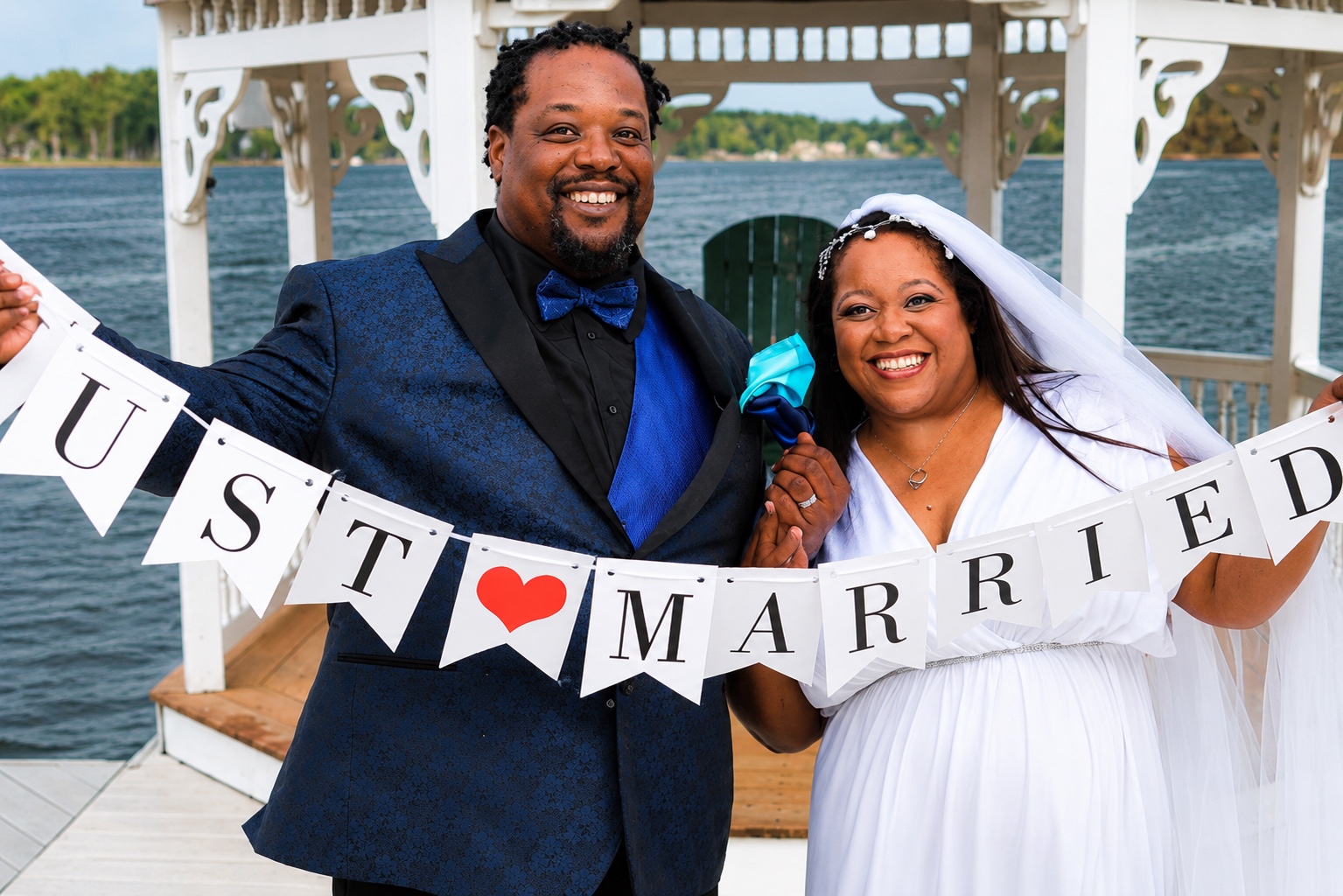 Wedding couple holding just married banner